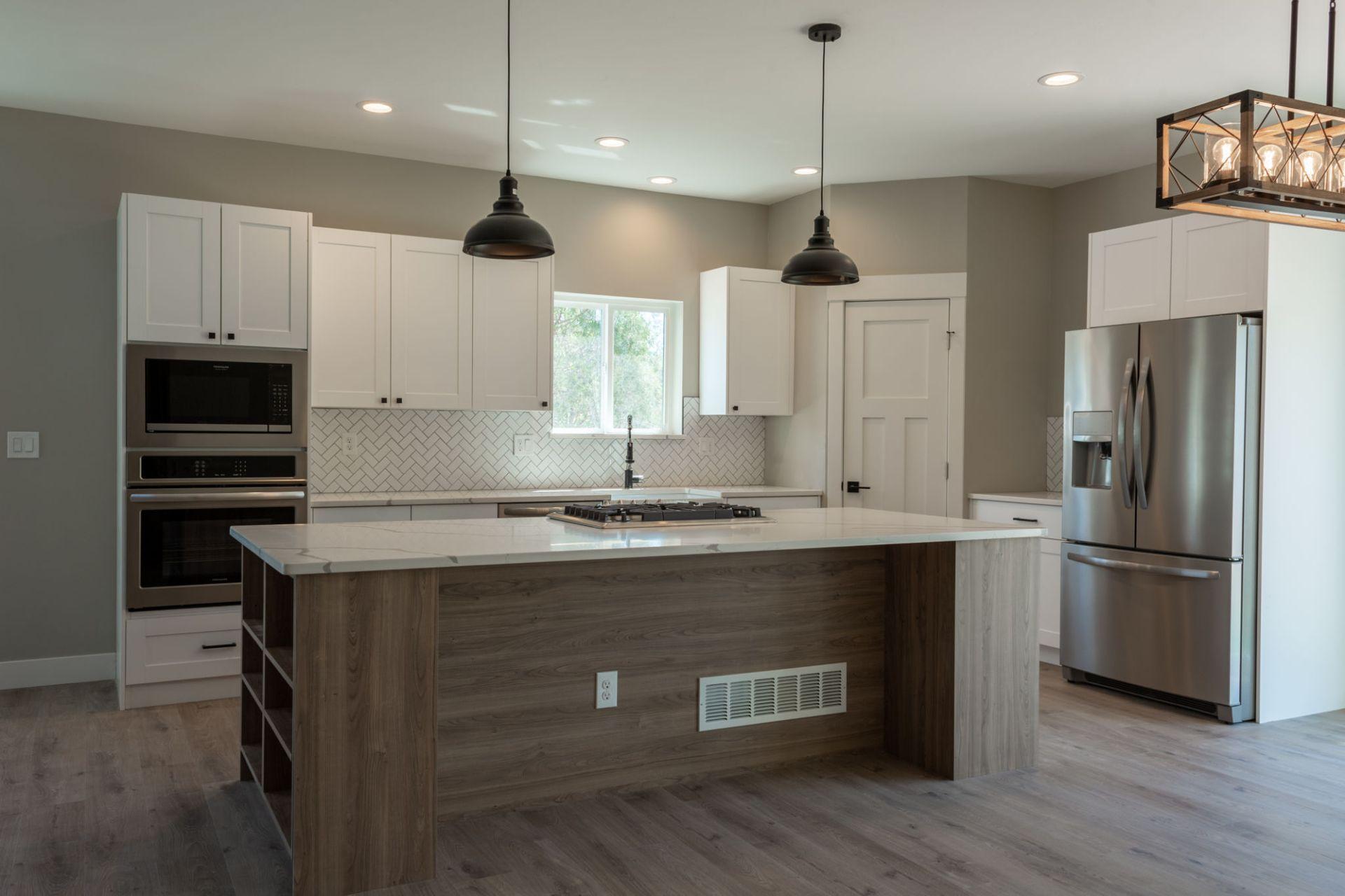 After photo of a fully remodeled kitchen with updated cabinets, countertops, and flooring completed by Urban Edge Construction in Cedar Rapids